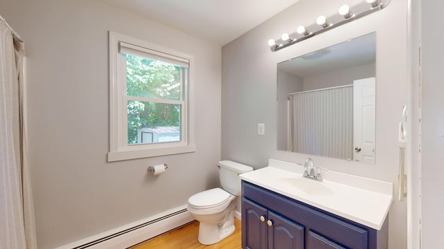118 Riverside Dr, Auburn, ME 04210 - full bath featuring baseboard heating, vanity, toilet, wood finished floors, and a shower with curtain