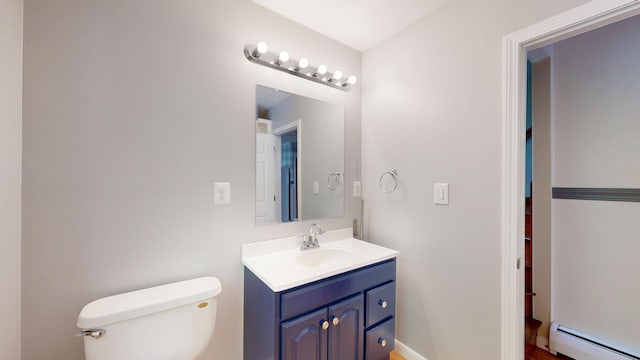 118 Riverside Dr, Auburn, ME 04210 - bathroom featuring a baseboard heating unit, toilet, and vanity