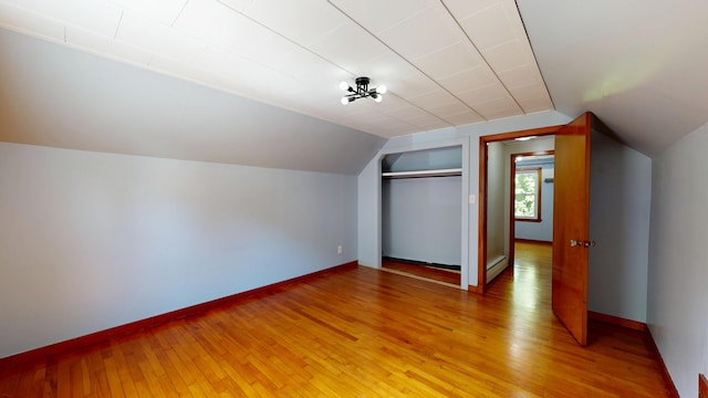 118 Riverside Dr, Auburn, ME 04210 - bonus room featuring a baseboard heating unit, lofted ceiling, light wood-type flooring, and baseboards