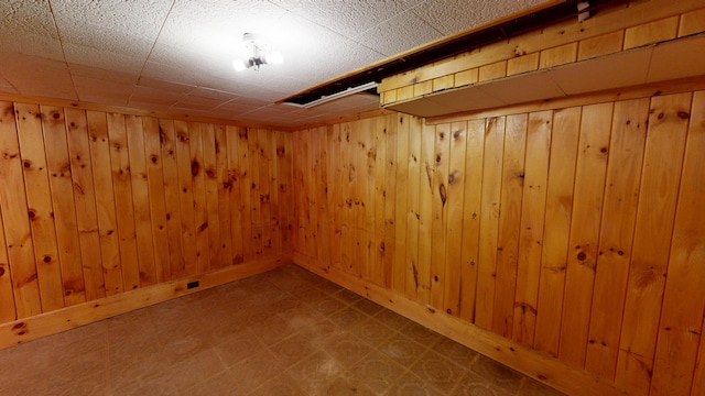 118 Riverside Dr, Auburn, ME 04210 - finished basement with tile patterned floors, wooden walls, and baseboards