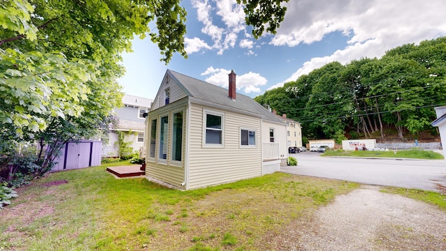 118 Riverside Dr, Auburn, ME 04210 - view of side of home featuring a chimney and a lawn