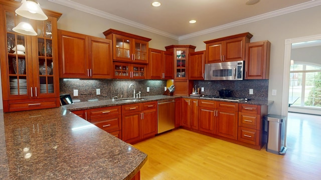 67 Joans Hill Rd, Bangor, ME 04401 - kitchen with appliances with stainless steel finishes, a sink, light wood finished floors, decorative backsplash, and crown molding