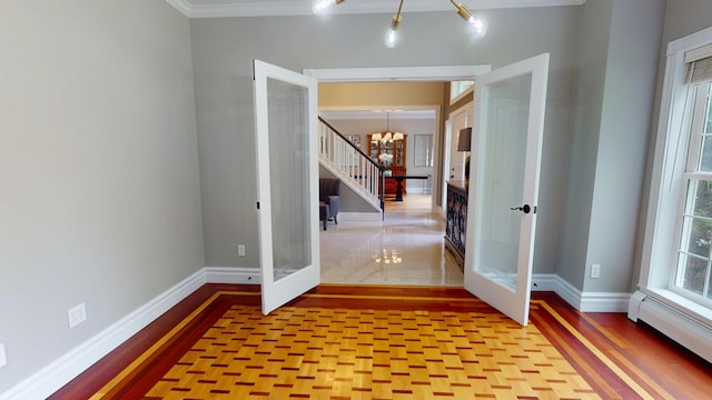 67 Joans Hill Rd, Bangor, ME 04401 - entryway featuring french doors, a chandelier, a baseboard radiator, baseboards, and crown molding