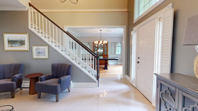 67 Joans Hill Rd, Bangor, ME 04401 - entrance foyer featuring ornamental molding, a chandelier, a baseboard heating unit, healthy amount of natural light, and stairway