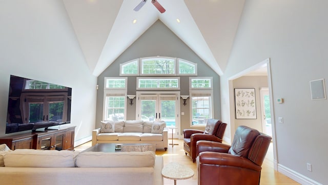 67 Joans Hill Rd, Bangor, ME 04401 - living room with light wood finished floors, a ceiling fan, baseboard heating, high vaulted ceiling, and baseboards