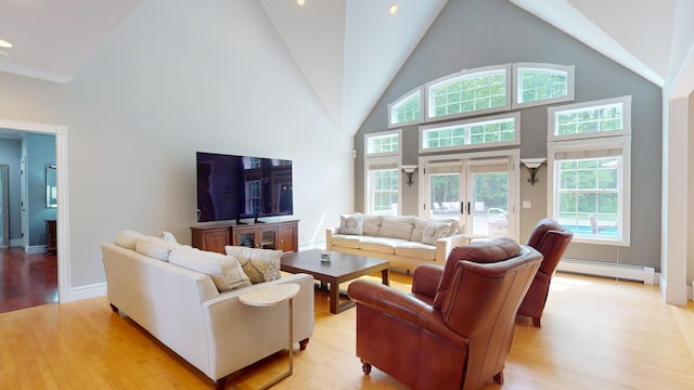 67 Joans Hill Rd, Bangor, ME 04401 - living room featuring baseboard heating, light wood finished floors, high vaulted ceiling, plenty of natural light, and baseboards