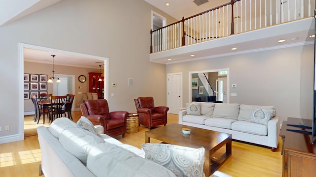 67 Joans Hill Rd, Bangor, ME 04401 - living area featuring a towering ceiling, light wood finished floors, recessed lighting, crown molding, and stairs
