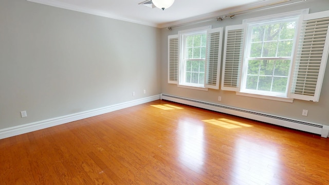 67 Joans Hill Rd, Bangor, ME 04401 - empty room with healthy amount of natural light, wood finished floors, baseboard heating, ornamental molding, and baseboards