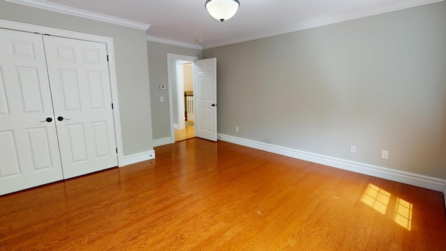 67 Joans Hill Rd, Bangor, ME 04401 - unfurnished bedroom featuring baseboards, wood finished floors, a closet, and ornamental molding
