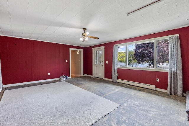 95 Riverview Dr, Gardiner, ME 04345 - empty room with a baseboard radiator, ceiling fan, baseboards, and wood walls