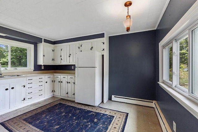 95 Riverview Dr, Gardiner, ME 04345 - kitchen with freestanding refrigerator, a baseboard radiator, healthy amount of natural light, a sink, and crown molding