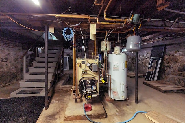 95 Riverview Dr, Gardiner, ME 04345 - unfinished below grade area with electric water heater, stairs, and a heating unit
