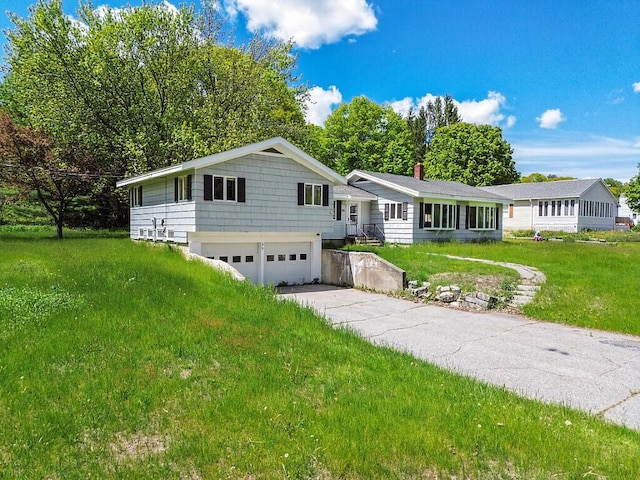 95 Riverview Dr, Gardiner, ME 04345 - ranch-style home with a garage, concrete driveway, and a front yard