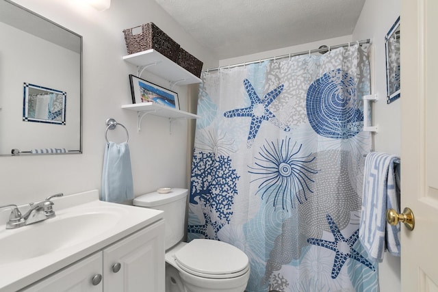 1801 Post Rd Unit 144, Wells, ME 04090 - bathroom featuring toilet, vanity, a textured ceiling, and a shower with shower curtain
