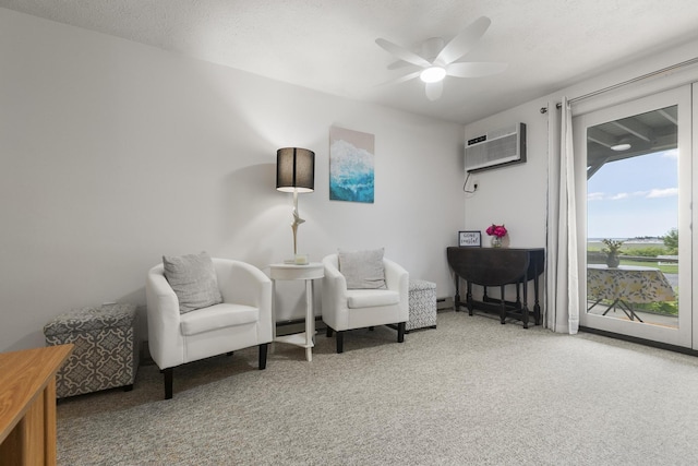 1801 Post Rd Unit 144, Wells, ME 04090 - living area with carpet flooring, a wall unit AC, a ceiling fan, and baseboard heating