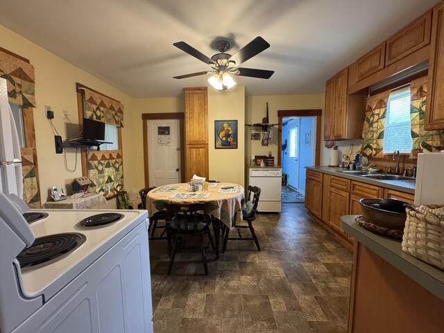 41 S Main St, Guilford, ME 04443 - kitchen featuring white electric range oven, a sink, stone finish flooring, brown cabinets, and ceiling fan