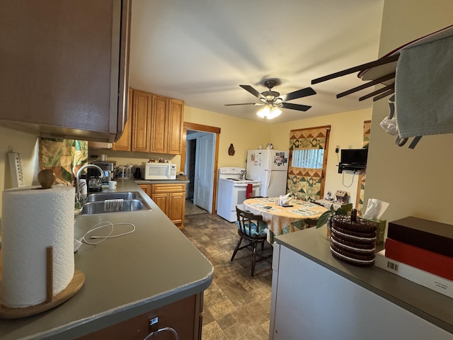 41 S Main St, Guilford, ME 04443 - kitchen with white appliances, a sink, a ceiling fan, dark floors, and brown cabinetry