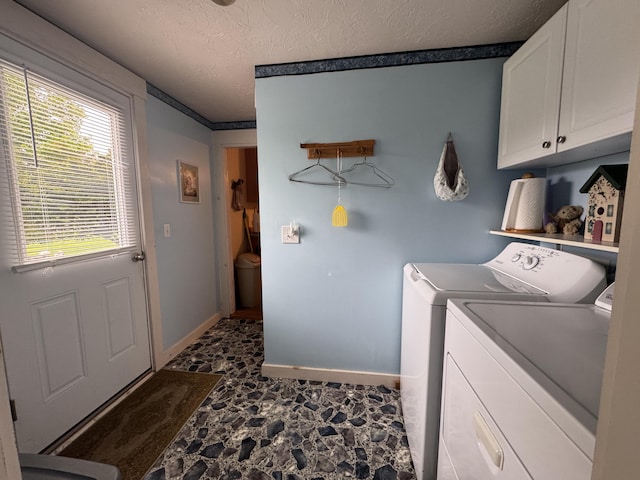 41 S Main St, Guilford, ME 04443 - washroom with cabinet space, separate washer and dryer, stone finish flooring, a textured ceiling, and baseboards