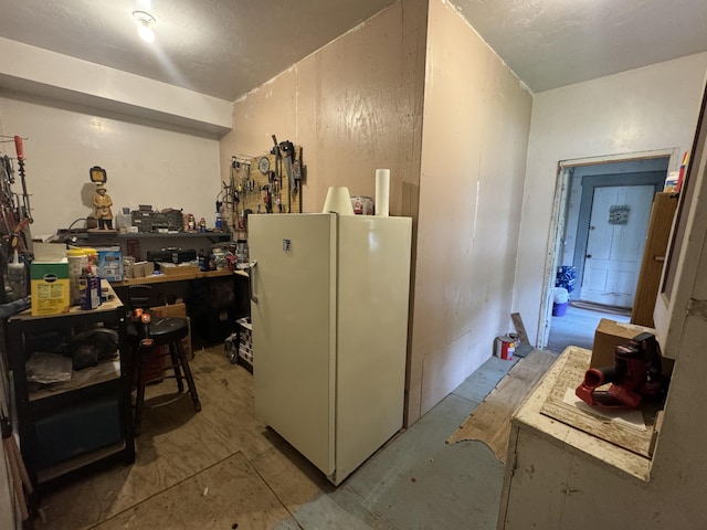 41 S Main St, Guilford, ME 04443 - kitchen featuring freestanding refrigerator and unfinished concrete floors