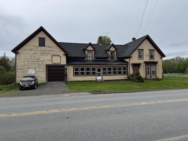 41 S Main St, Guilford, ME 04443 - view of front of home with a chimney, asphalt driveway, and a front lawn