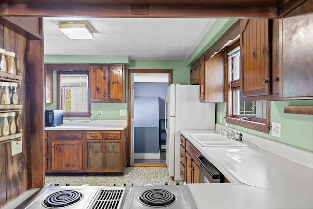 1 Fall St, Biddeford, ME 04005 - kitchen with a sink, light countertops, dishwashing machine, black microwave, and brown cabinets