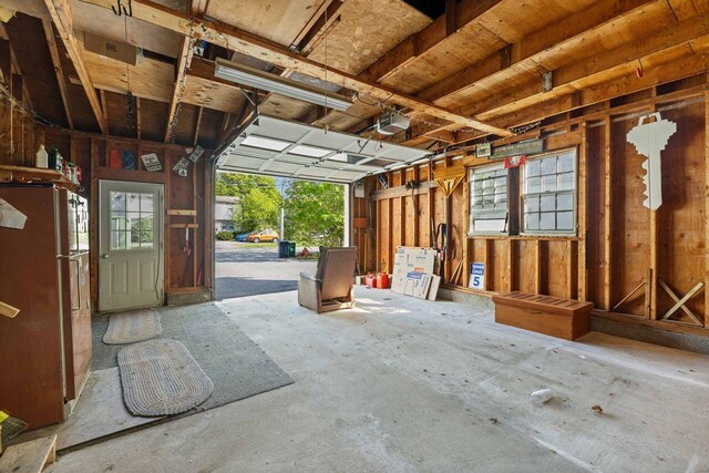1 Fall St, Biddeford, ME 04005 - garage with freestanding refrigerator and a garage door opener