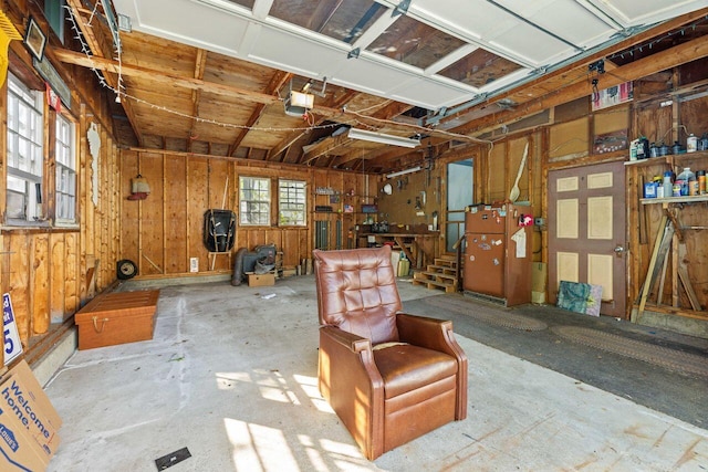 1 Fall St, Biddeford, ME 04005 - garage featuring a garage door opener and wood walls
