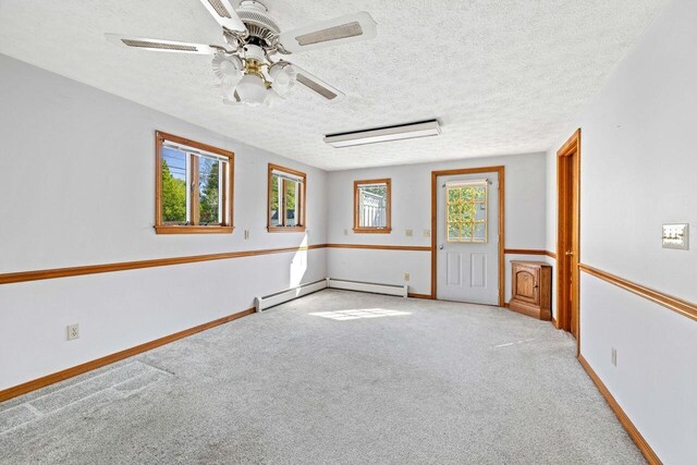 1 Fall St, Biddeford, ME 04005 - carpeted empty room featuring a baseboard radiator, ceiling fan, a textured ceiling, and baseboards