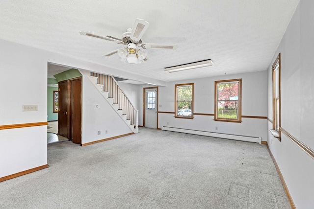 1 Fall St, Biddeford, ME 04005 - spare room with baseboard heating, stairs, carpet, a textured ceiling, and baseboards