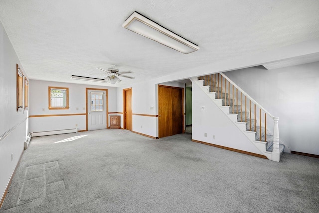 1 Fall St, Biddeford, ME 04005 - unfurnished living room with carpet, stairway, ceiling fan, baseboards, and a baseboard heating unit