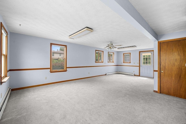 1 Fall St, Biddeford, ME 04005 - empty room featuring a baseboard heating unit, a textured ceiling, carpet, and ceiling fan