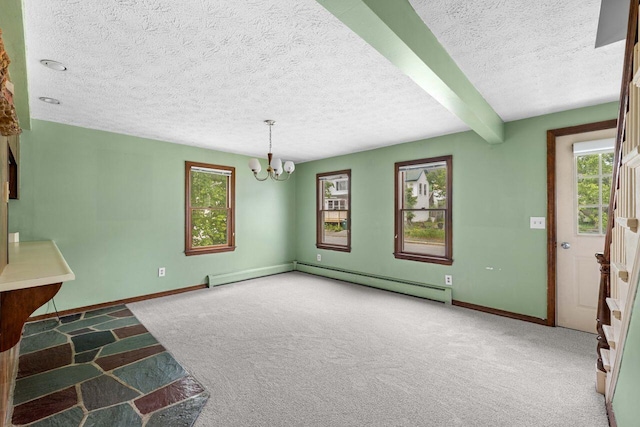 1 Fall St, Biddeford, ME 04005 - unfurnished dining area with carpet flooring, a chandelier, a textured ceiling, baseboards, and healthy amount of natural light