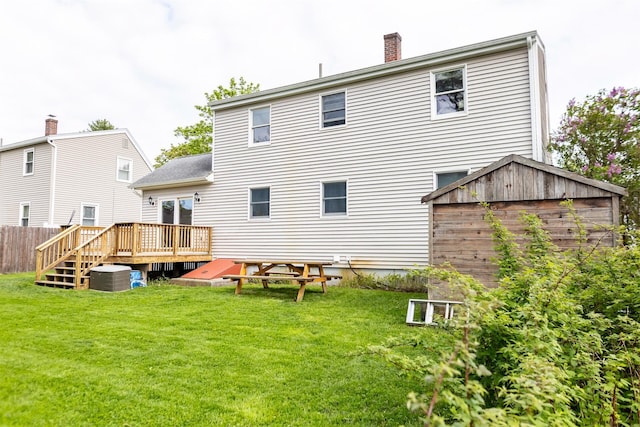 22 Penn Ave, Portland, ME 04103 - back of property with a deck, a lawn, cooling unit, and a chimney