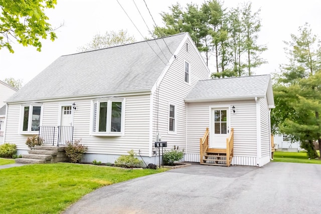 22 Penn Ave, Portland, ME 04103 - cape cod house featuring a shingled roof and a front lawn