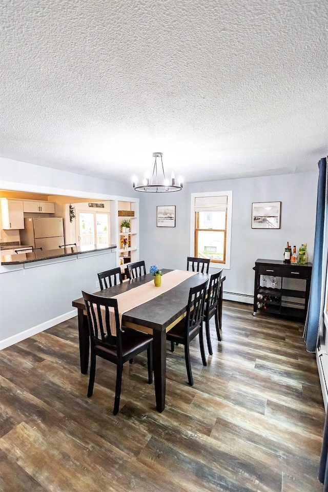 22 Penn Ave, Portland, ME 04103 - dining room featuring a chandelier, a textured ceiling, a baseboard heating unit, and dark wood-type flooring