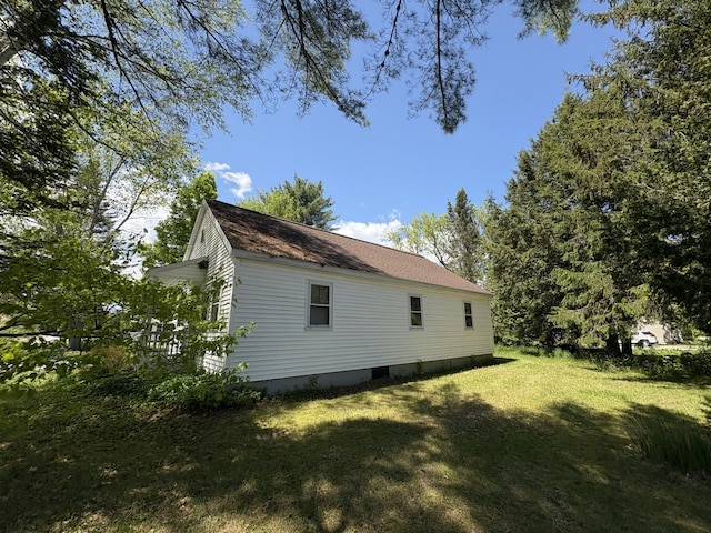66 Pleasant St, Passadumkeag, ME 04461 - view of home's exterior featuring a lawn and roof with shingles