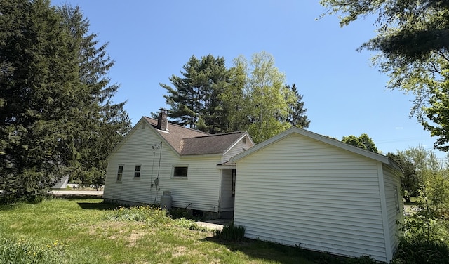 66 Pleasant St, Passadumkeag, ME 04461 - view of home's exterior featuring a chimney and a lawn