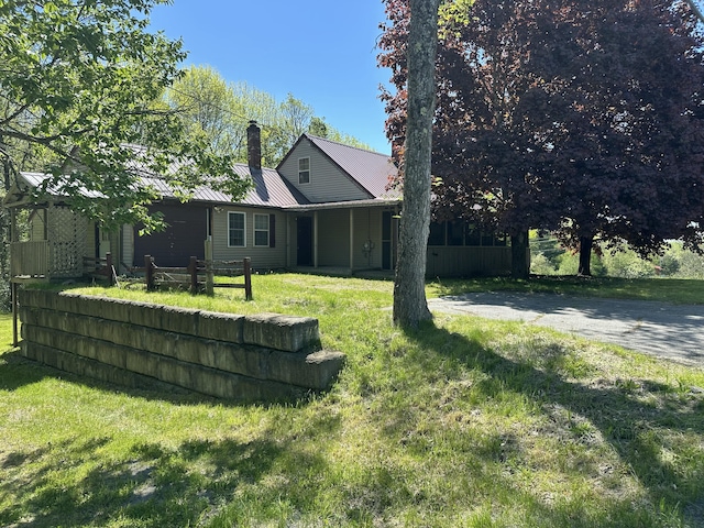 5 Grant Rd, Saint Albans, ME 04971 - view of front of property featuring a chimney, a front yard, and metal roof