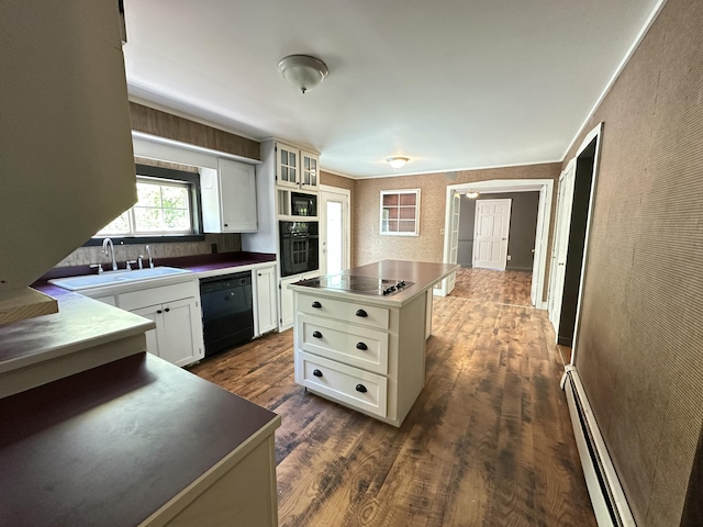 5 Grant Rd, Saint Albans, ME 04971 - kitchen with black appliances, a sink, stainless steel countertops, baseboard heating, and dark wood-style floors