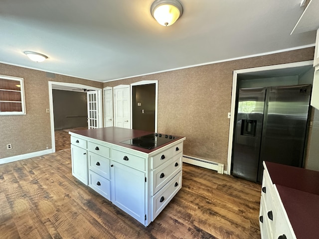 5 Grant Rd, Saint Albans, ME 04971 - kitchen featuring a baseboard radiator, dark countertops, stainless steel fridge, white cabinets, and dark wood finished floors