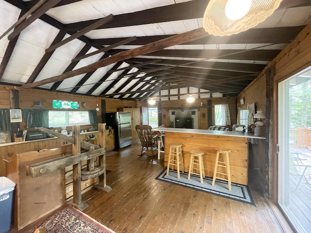 55 Sandy Bottom Rd, Turner, ME 04282 - kitchen with freestanding refrigerator, wood-type flooring, wooden walls, and healthy amount of natural light