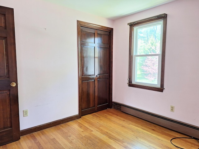 2 Gunstock Rd, Scarborough, ME 04074 - unfurnished bedroom featuring a baseboard radiator, light wood-style flooring, a closet, and baseboards