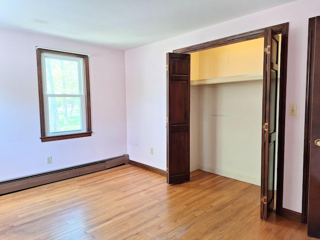 2 Gunstock Rd, Scarborough, ME 04074 - unfurnished bedroom featuring a baseboard radiator, light wood finished floors, a closet, and baseboards