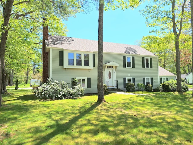 2 Gunstock Rd, Scarborough, ME 04074 - raised ranch featuring a chimney, a front yard, and roof with shingles