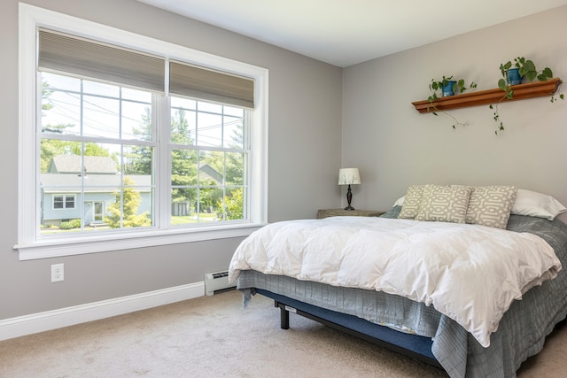 13 Daggett St, Portland, ME 04103 - carpeted bedroom featuring a baseboard heating unit, multiple windows, and baseboards