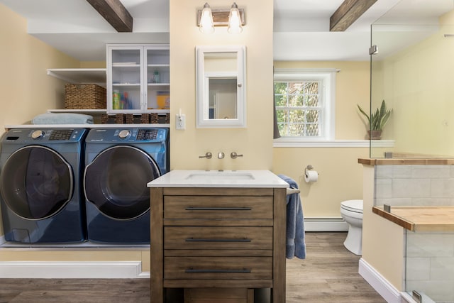 13 Daggett St, Portland, ME 04103 - full bathroom with washing machine and clothes dryer, a baseboard heating unit, wood finished floors, vanity, and toilet