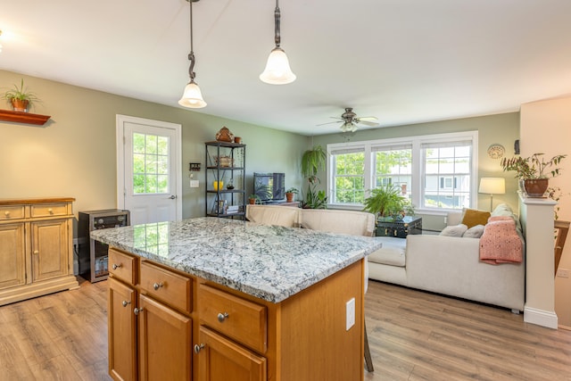 13 Daggett St, Portland, ME 04103 - kitchen with open floor plan, a center island, a ceiling fan, and light wood-type flooring
