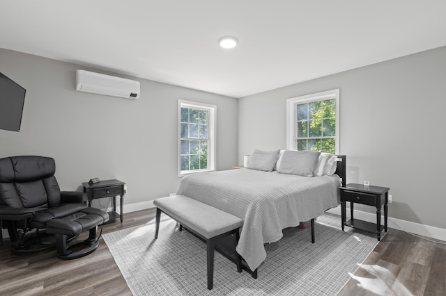 186 Yarmouth Rd, Gray, ME 04039 - bedroom featuring a wall mounted AC, wood finished floors, and baseboards