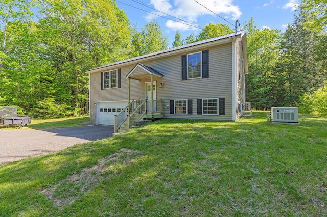 186 Yarmouth Rd, Gray, ME 04039 - bi-level home featuring asphalt driveway, an attached garage, and a front lawn