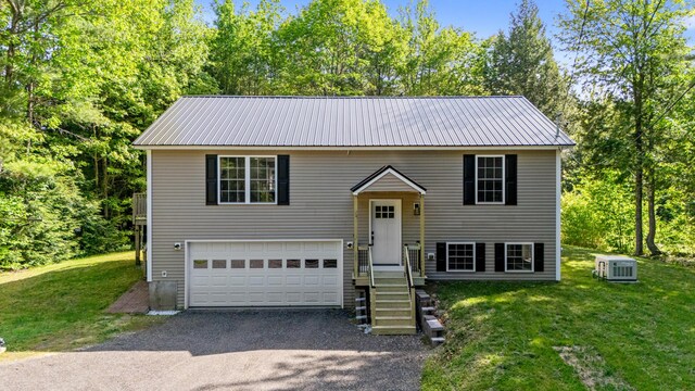 186 Yarmouth Rd, Gray, ME 04039 - split foyer home featuring metal roof, a front lawn, an attached garage, and driveway
